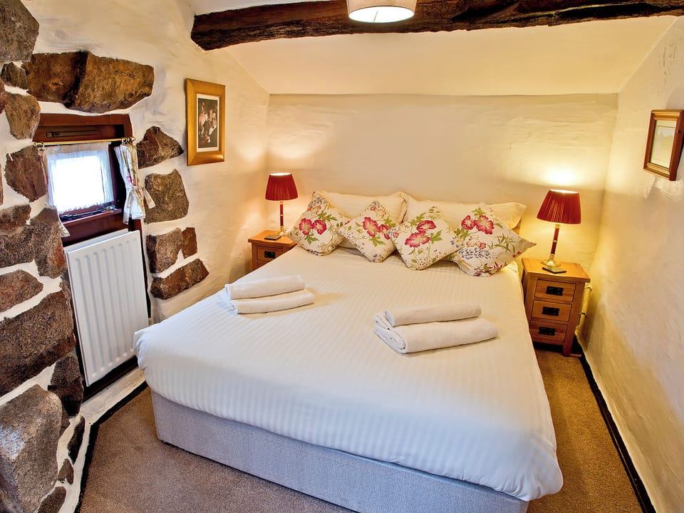 Comfortable double bedroom with exposed wooden beams | Stanley Ghyll Cottage - Bridge End Farm Cottages, Boot, near Eskdale