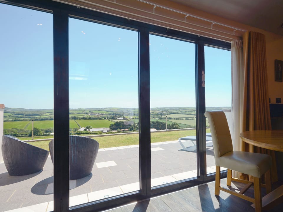 Living area, with full length doors to the outside | Milky Way - Wooldown Holiday Cottages, Marhamchurch, near Bude