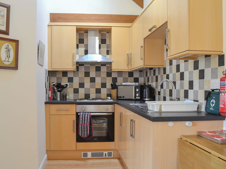 Tiled kitchen with a range of units and appliances | Stables Cottage - Mackinder Farms, Brayton, Selby