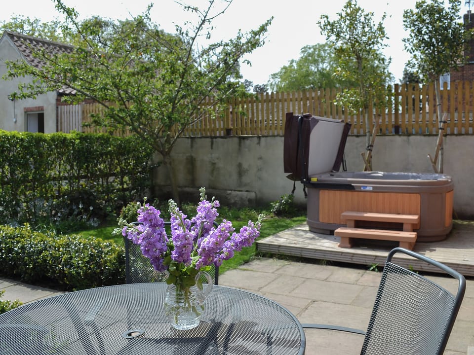Paved patio with furniture and hot tub | The Forge - Mackinder Farms, Brayton, Selby