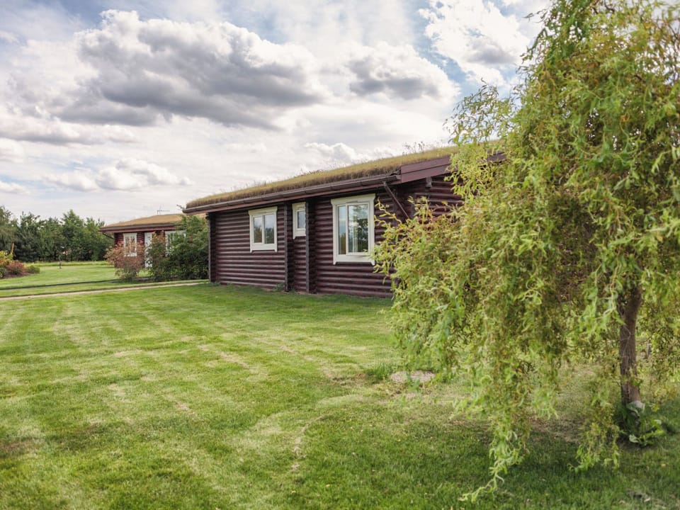 Lawned gardens surround the property | Partridge Lodge - Mackinder Farms, Brayton, Selby