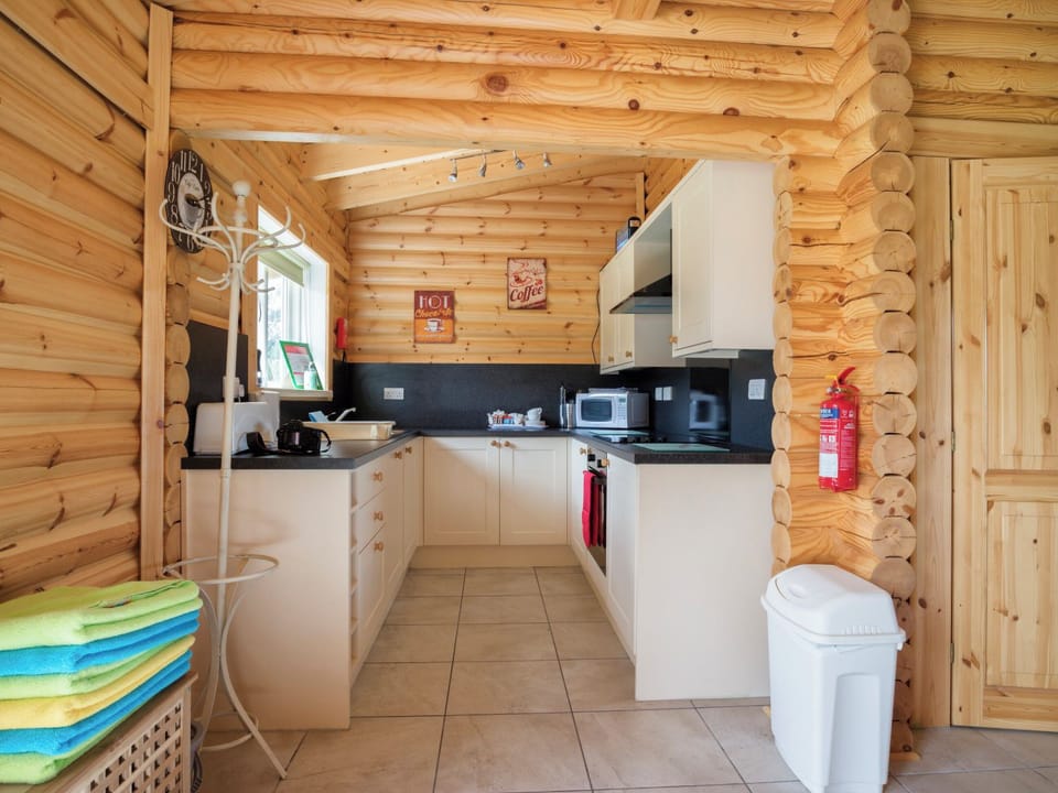 A compact well-fitted galley style kitchen | Quail Lodge - Mackinder Farms, Brayton, Selby