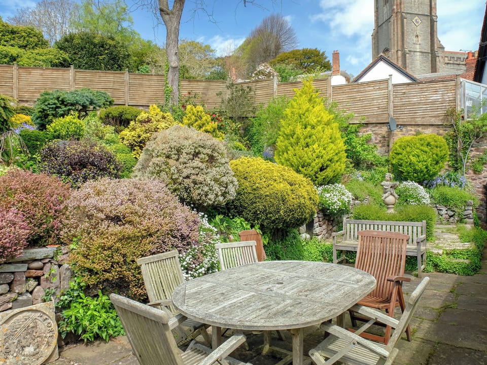 Sitting out area in the picturesque garden | Pilgrim Corner - Vicarage Road Holiday Cottages, Minehead