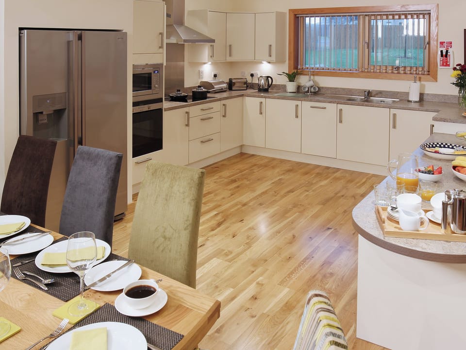 The well equipped kitchen has a wealth of appliances and a breakfast bar for informal meal times | HomelandsDrummochy, Lundin Links near Anstruther