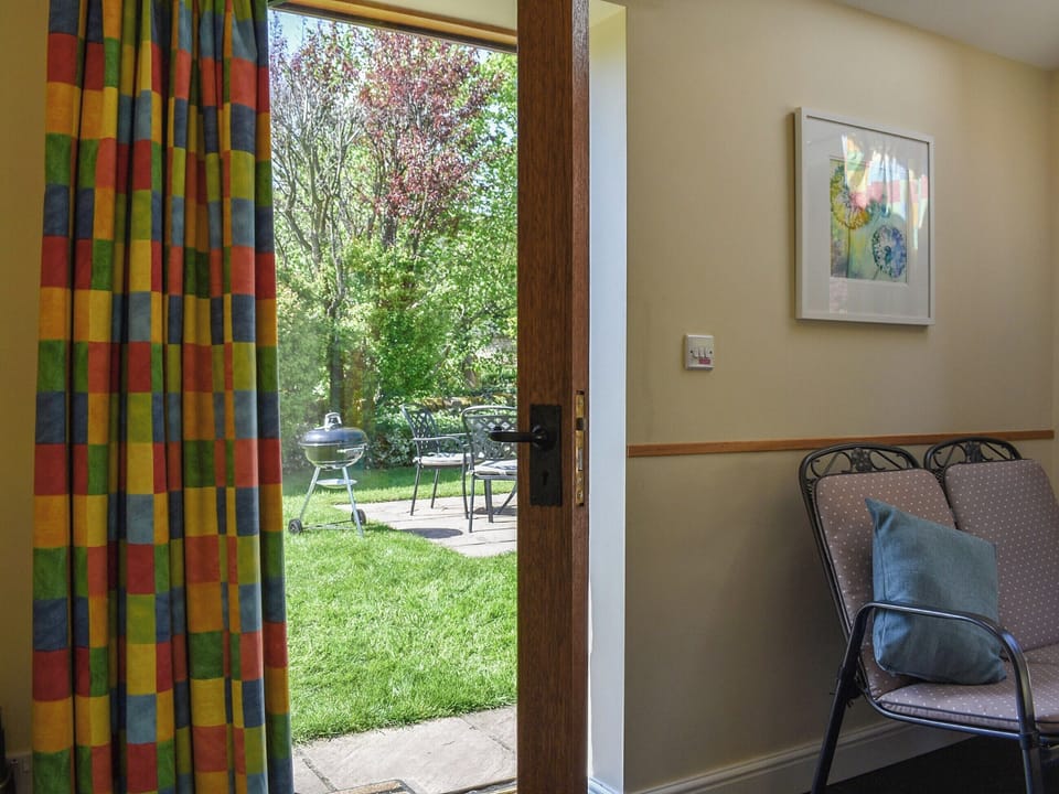 Garden room with glazed door into garden | Acorn Cottage, Ashover