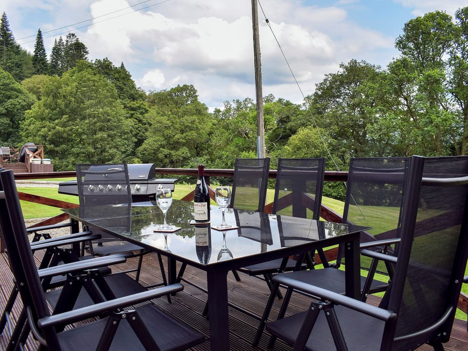 Decked area with garden furniture and gas BBQ | Brandoch Lodge - Kinnaird Estate Cottages, By Dunkeld, Pitlochry