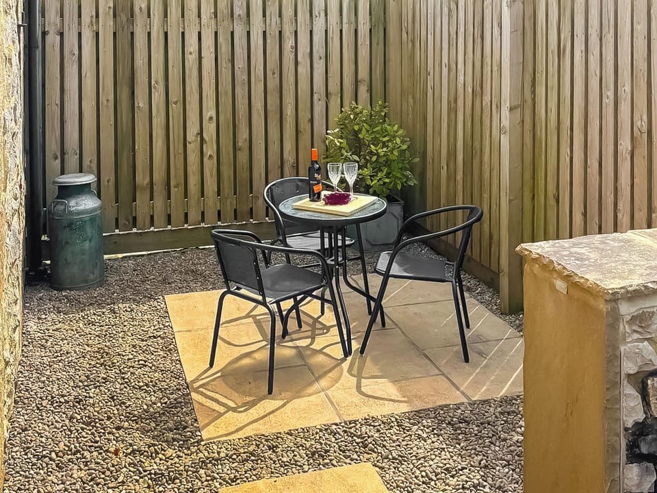 Enclosed private patio area with outdoor seating | Milking Parlour - Cotterill Farm, Biggin by Hartington, near Buxton