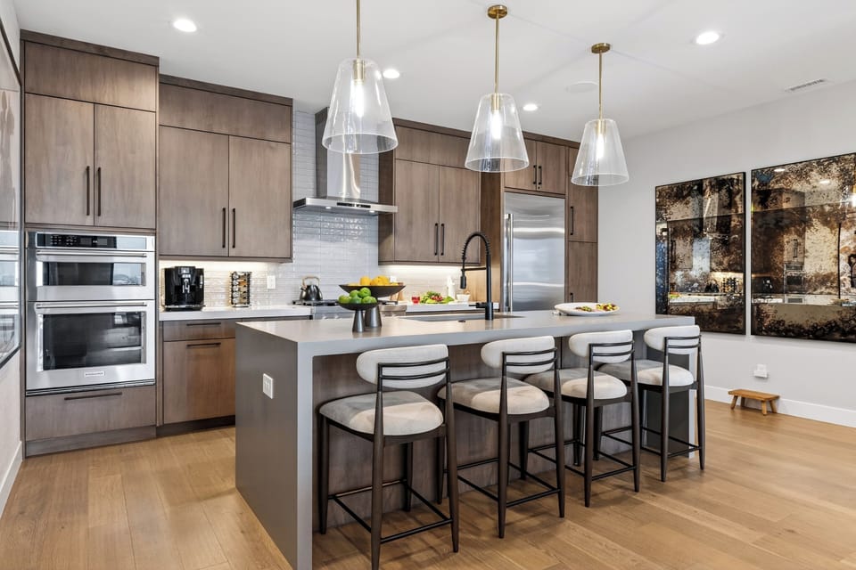 Chef-style kitchen with a spacious island, 4 counter seats, and premium stainless steel appliances—perfect for après-ski bites and big breakfasts.