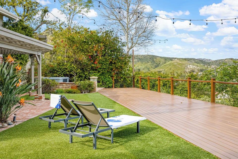 Lounge under the string lights with sweeping hillside views—your private, sun-soaked backyard escape.