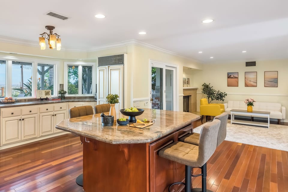 Cook, chat, and take in the views—this airy chef’s kitchen features a large island and picture windows overlooking the hills.