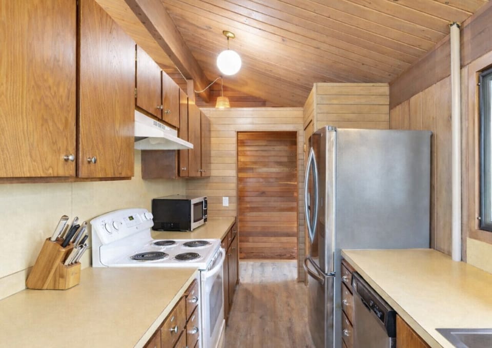 Narrow kitchen layout with fully stocked amenities