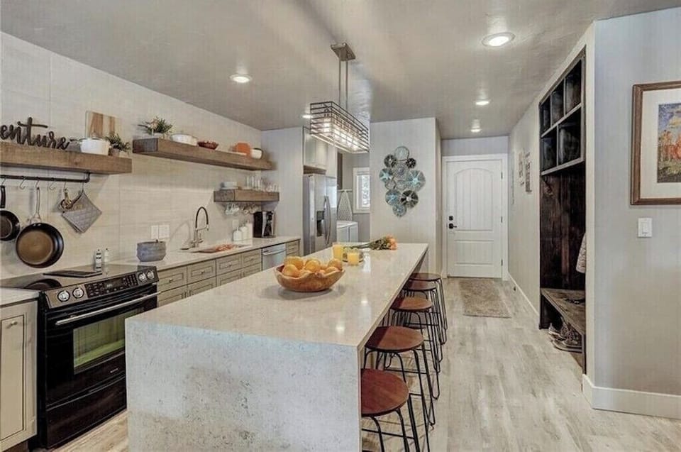 Gather around the spacious island in your fully-equipped kitchen, where marble countertops and rustic charm create the perfect cooking sanctuary.