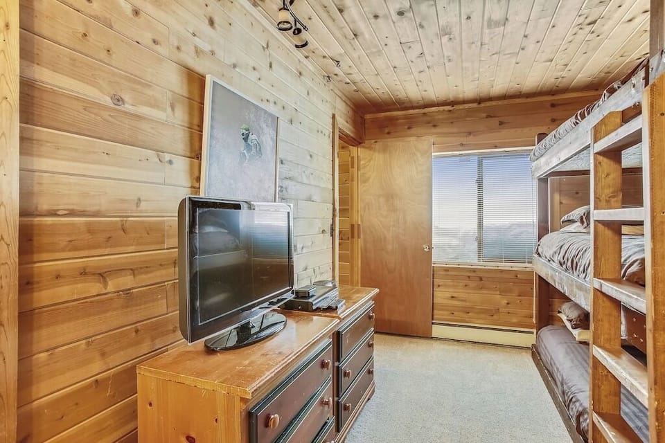 Cozy wooden bunk room where you'll drift off surrounded by warm pine walls and rustic charm.