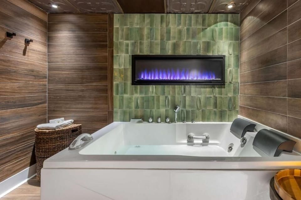 Soak in a bubbling hot tub beside a glowing fireplace.