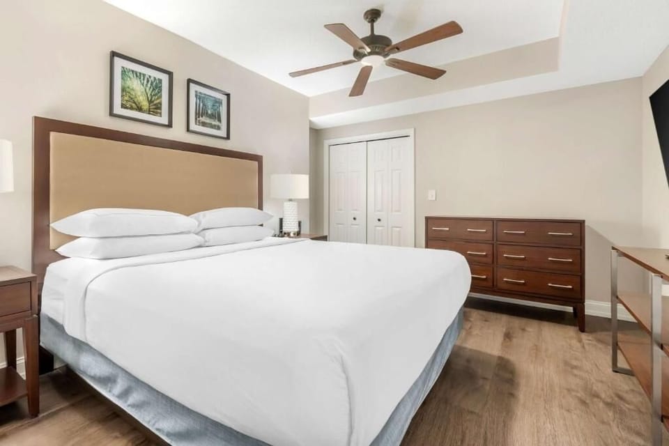 Stretch out and recharge in a calm, coastal bedroom.