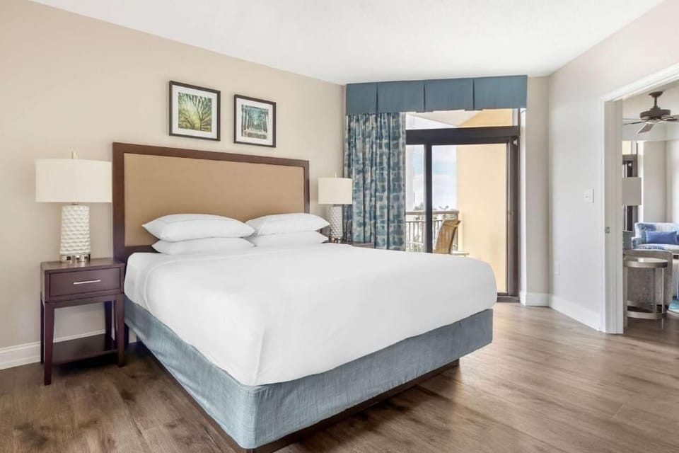 Unwind in crisp linens and step onto your private balcony.