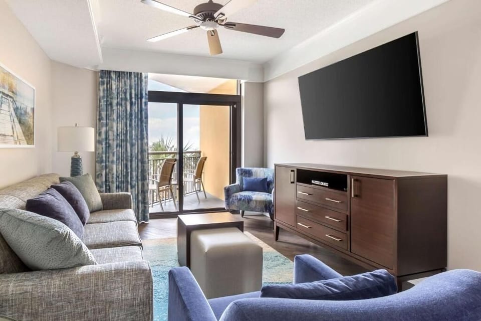 Lounge comfortably with a big TV and balcony sunlight.