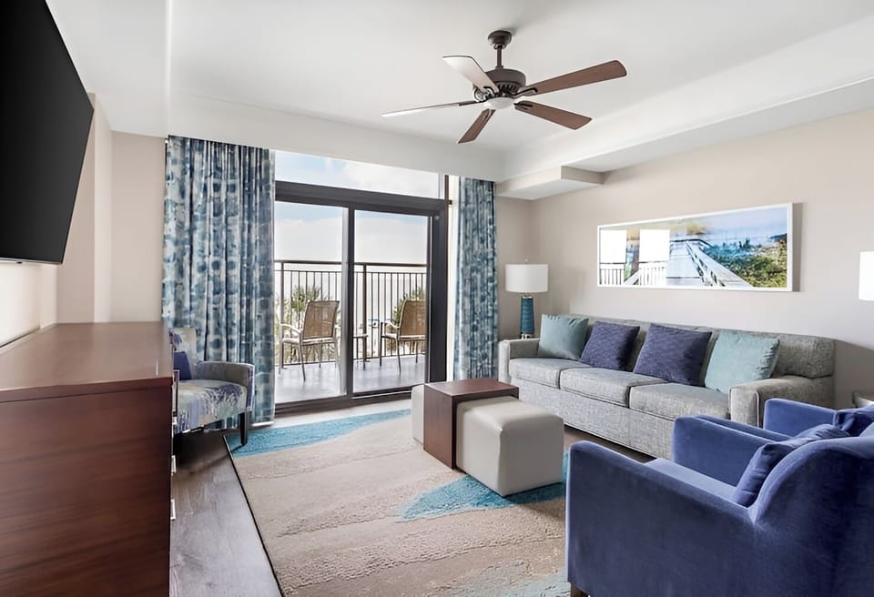 Gather on the sofa and savor breezy balcony views.