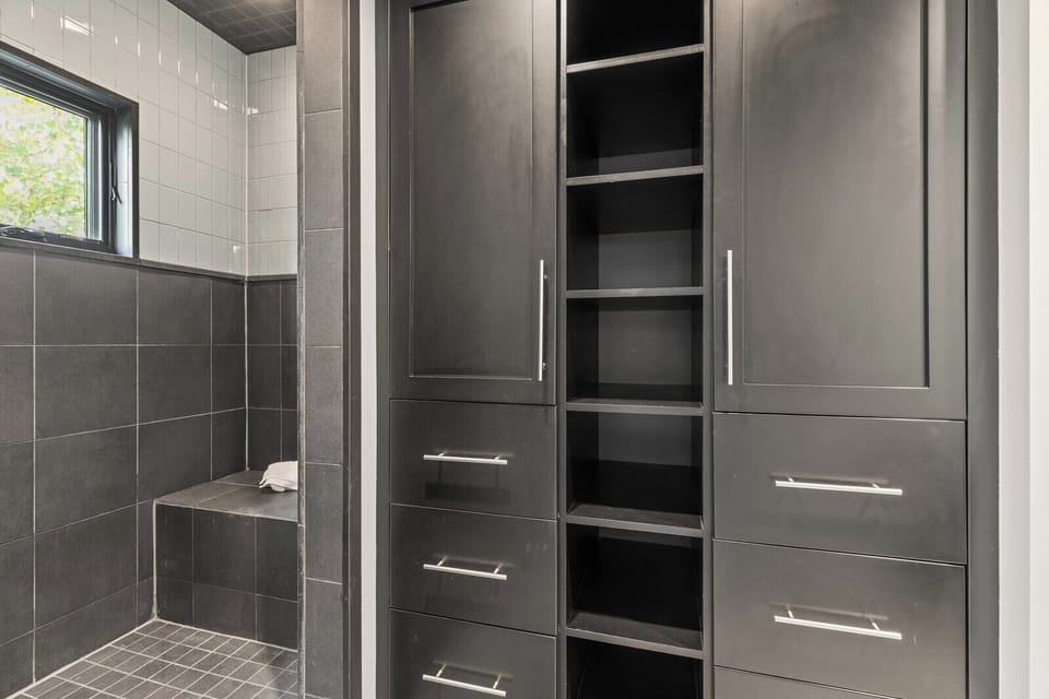 Additional view of guest bath shows sleek built-ins and hotel-style finishes.