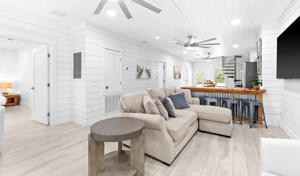 TV room: Smart TV, plush seating, lower floor