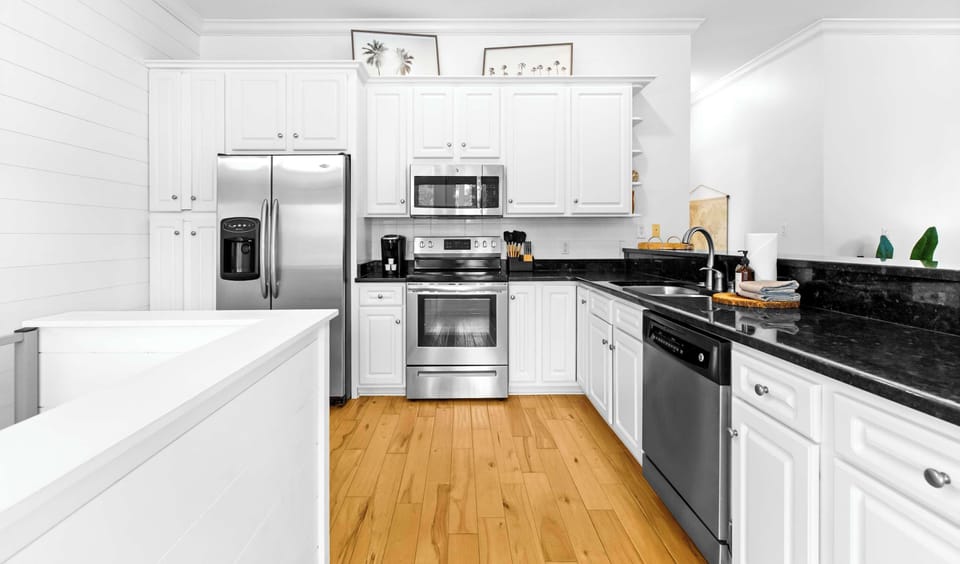 Kitchen: Drip coffee maker, KitchenAid appliances, island seating, cooking utensils, tableware
