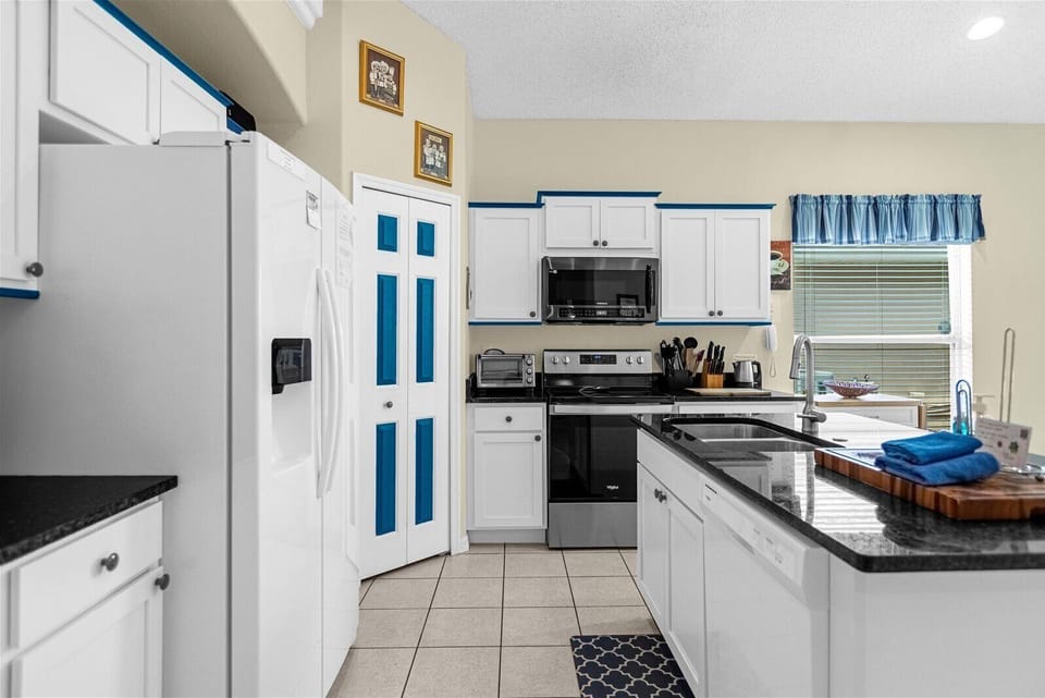 Kitchen Area With Stove, Microwave, And Dishwasher