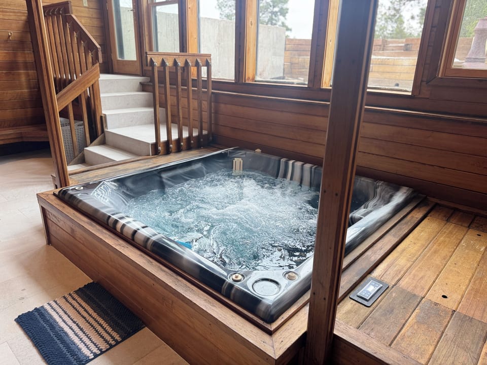 Indoor hot tub with 2-story windows overlooking the forest!