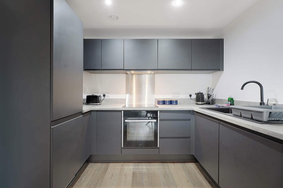A modern, fully equipped kitchen with sleek finishes and all the essentials you need to prepare home-cooked meals with ease during your stay.