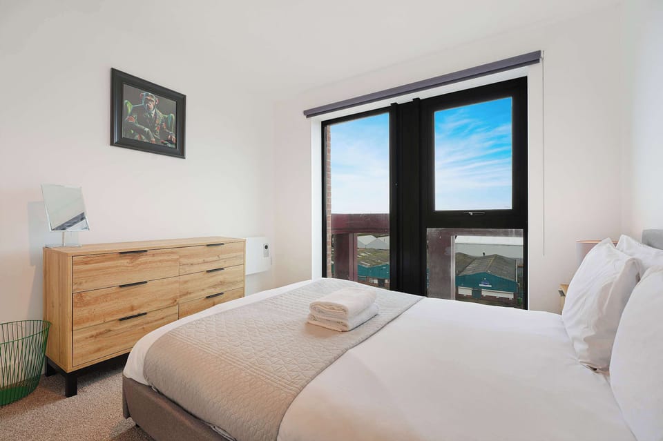 A calm and comfortable bedroom featuring a cosy double bed and convenient clothing storage, offering a relaxing space to unwind and settle in comfortably.