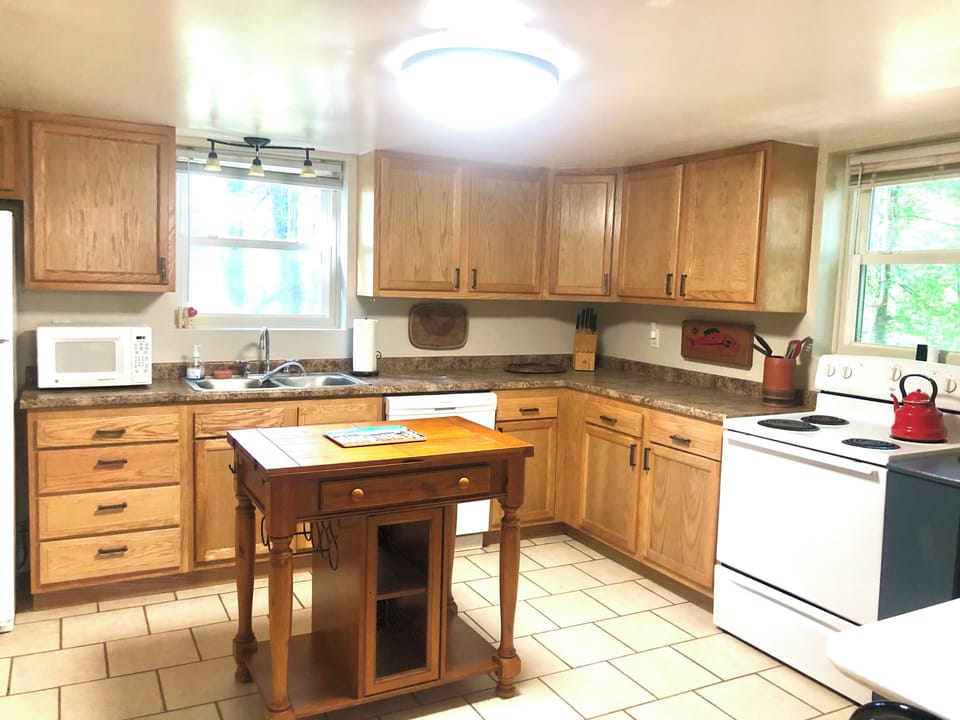 Spacious kitchen with small island and separate bistro table