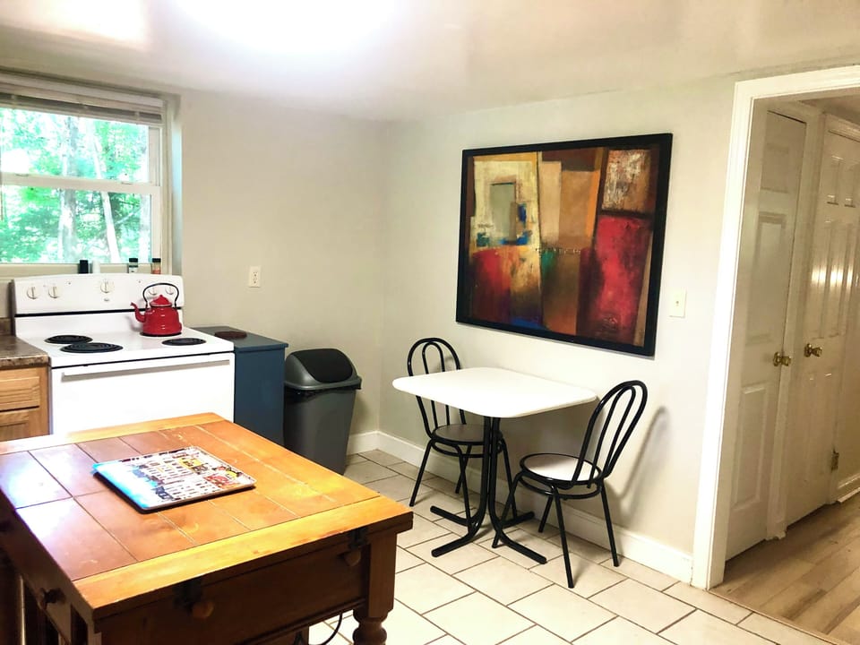 Kitchen includes both an expandable island piece (open “wings”) and bistro table