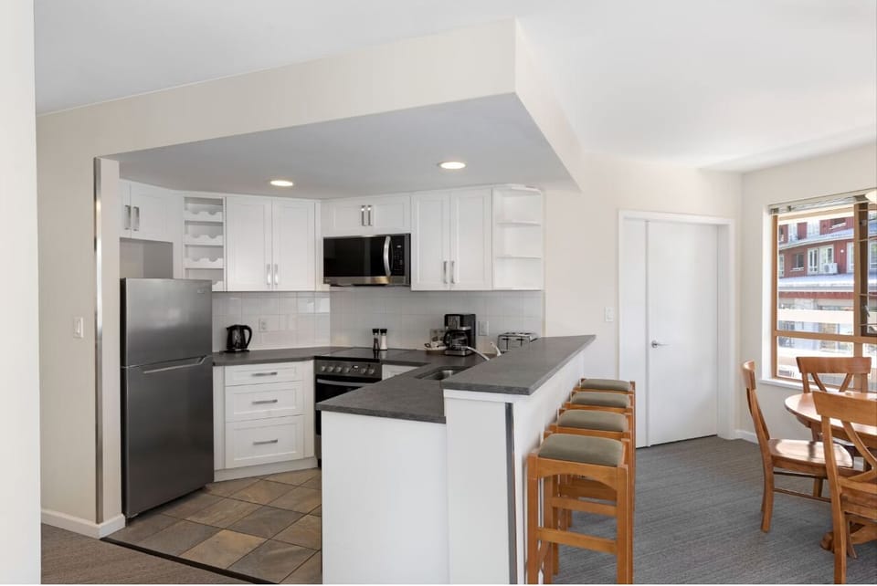 Cook effortlessly in the sleek kitchen with breakfast-bar seating.