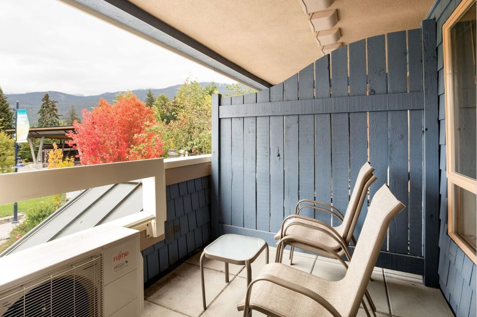 Sip morning coffee outside with crisp air and treetop views.