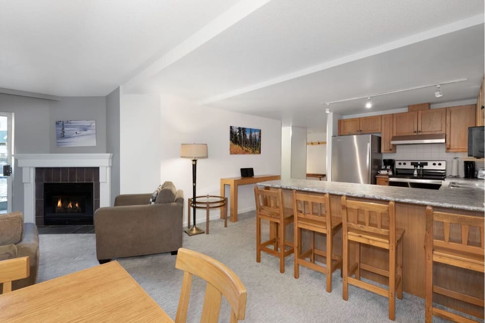 Gather by the fireplace in a bright, open great room.