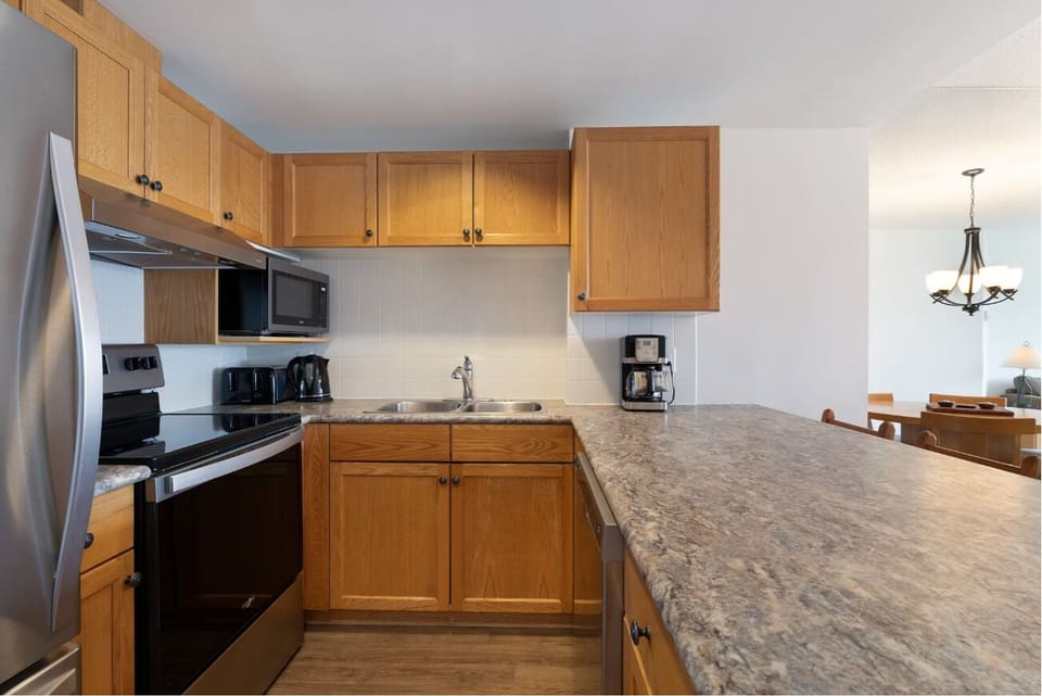 Prep easy meals on generous counters in the bright kitchen.