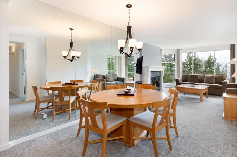 Gather by the cozy fireplace in this airy living space.