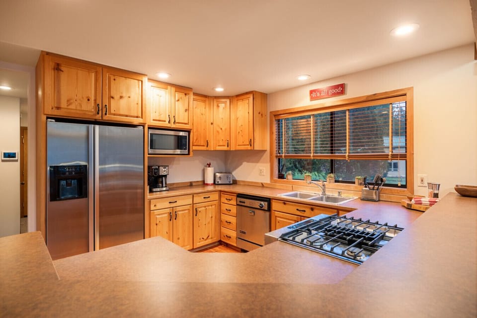 The kitchen is quite spacious and comes equipped with a generous selection of appliances, making it ideal for cooking and entertaining.