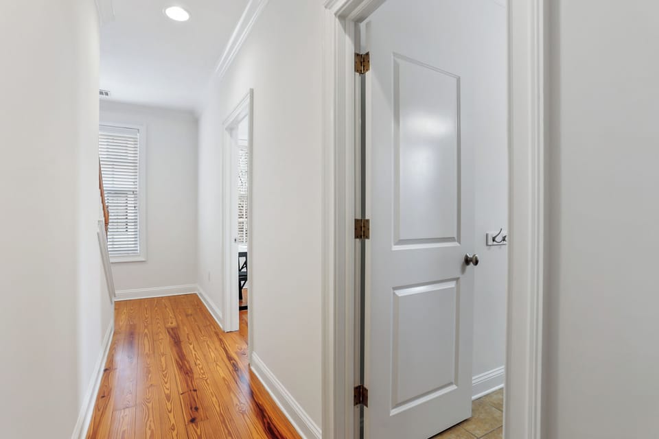 The hallway leads directly to the shared full bathroom serving both second-floor bedrooms.