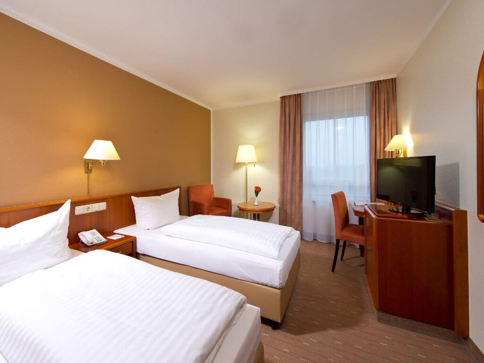Settle into twin comfort with warm lighting and room to breathe.