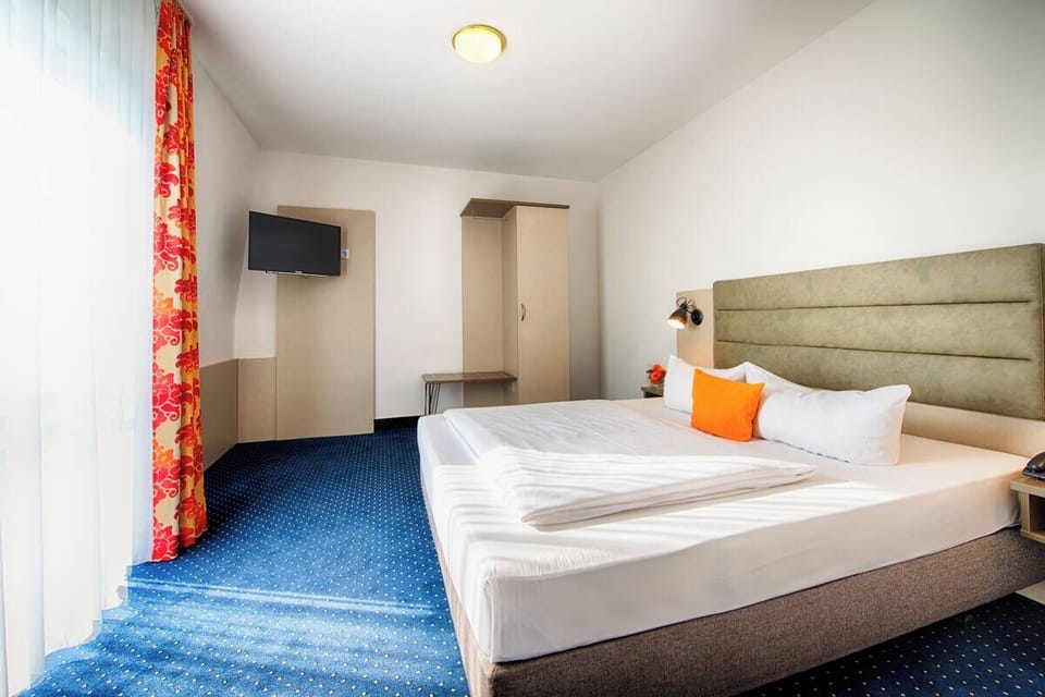 Wake up refreshed in smooth linens beside bright windows.