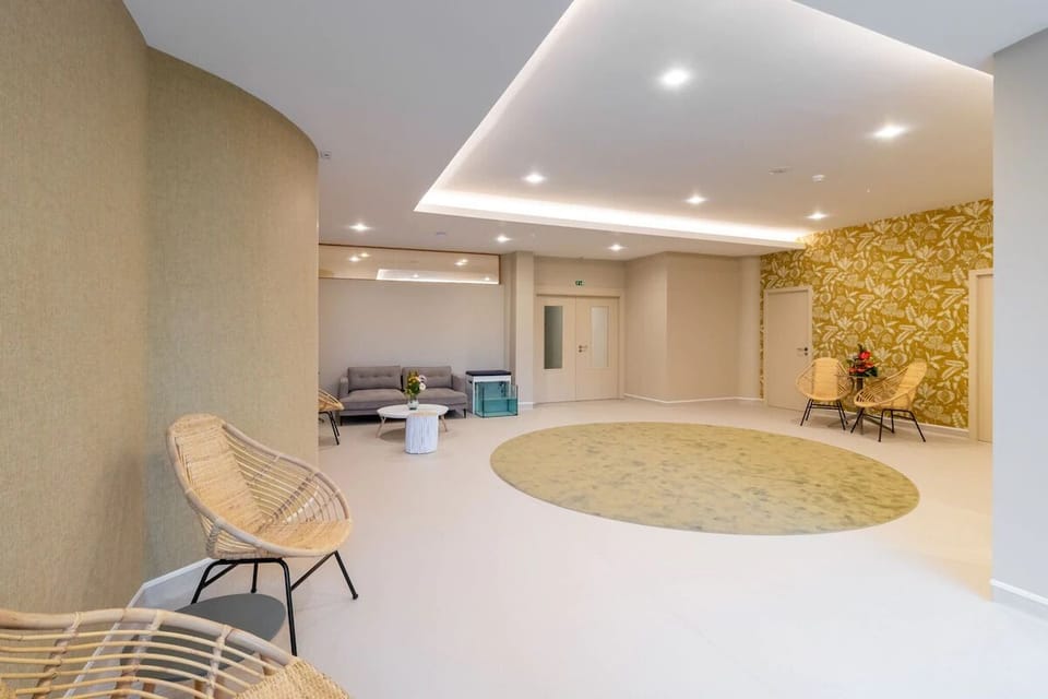 Unwind in the airy lobby with calm, open seating.