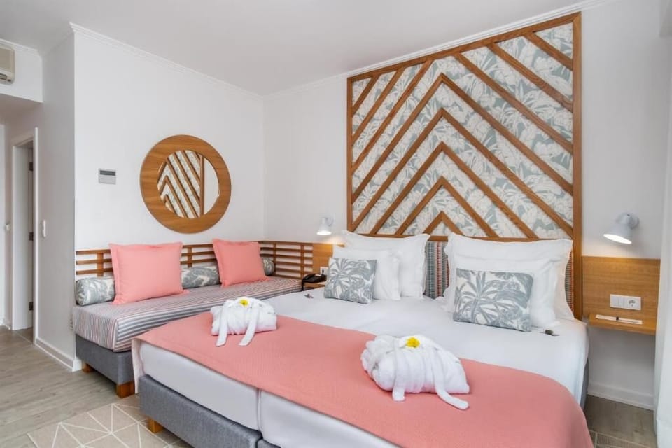 Recharge on plush beds with soft throws and calming tones.