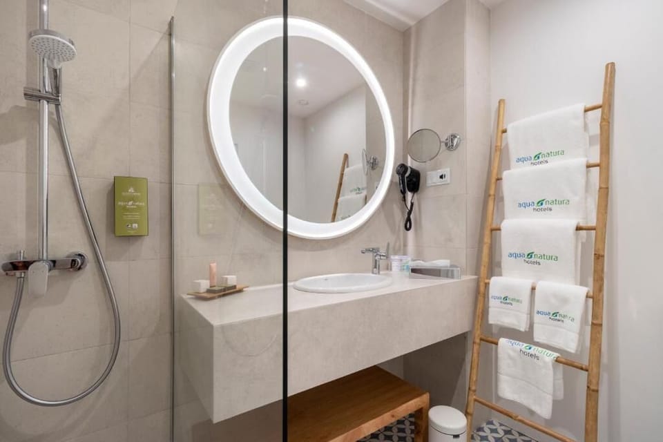 Refresh under a rainfall shower in a spa-like bath.