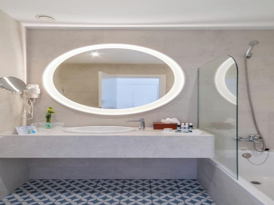 Unwind with a warm soak beneath soft, flattering mirror light