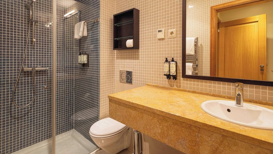 Refresh in a spotless walk-in shower with plush towels.