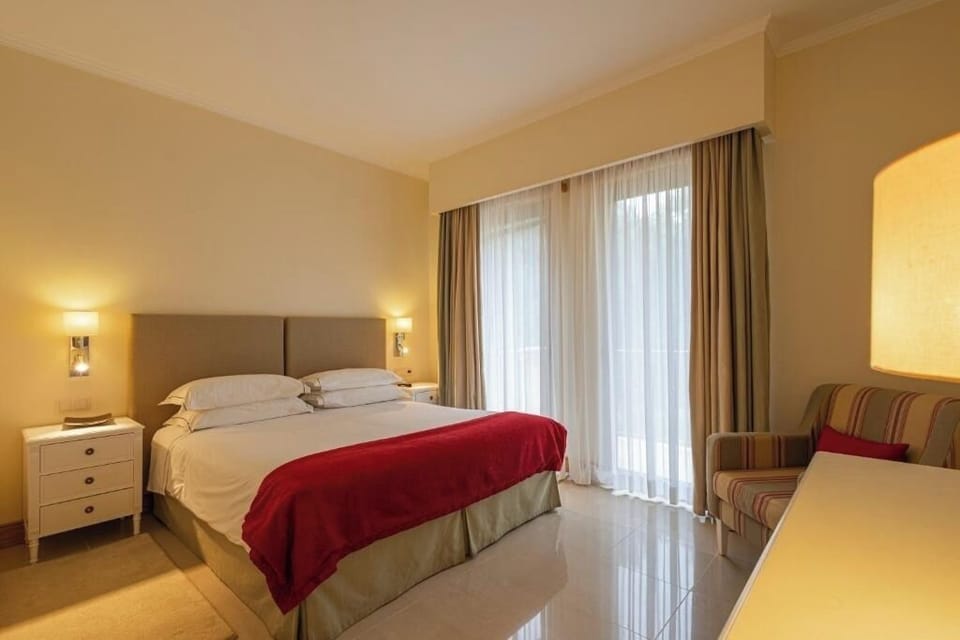 Relax into crisp linens and wake to sunlit balcony doors.