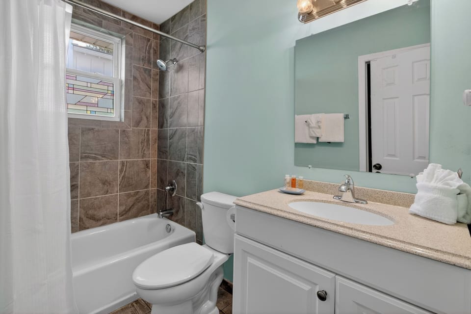 Bathroom 2 features a shower/tub combo.