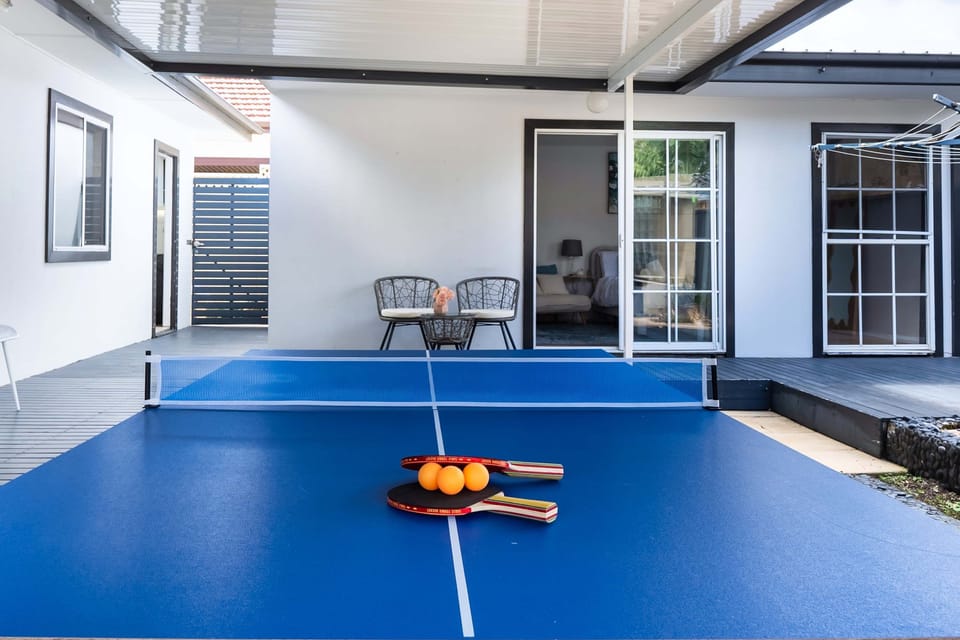 Huge outdoor entertaining area featuring an 8ft 3-in-1 table (billiards, ping-pong, and dining) with chairs. Includes additional comfortable seating, perfect for relaxing, socialising, and enjoying fun-filled moments with family and friends.