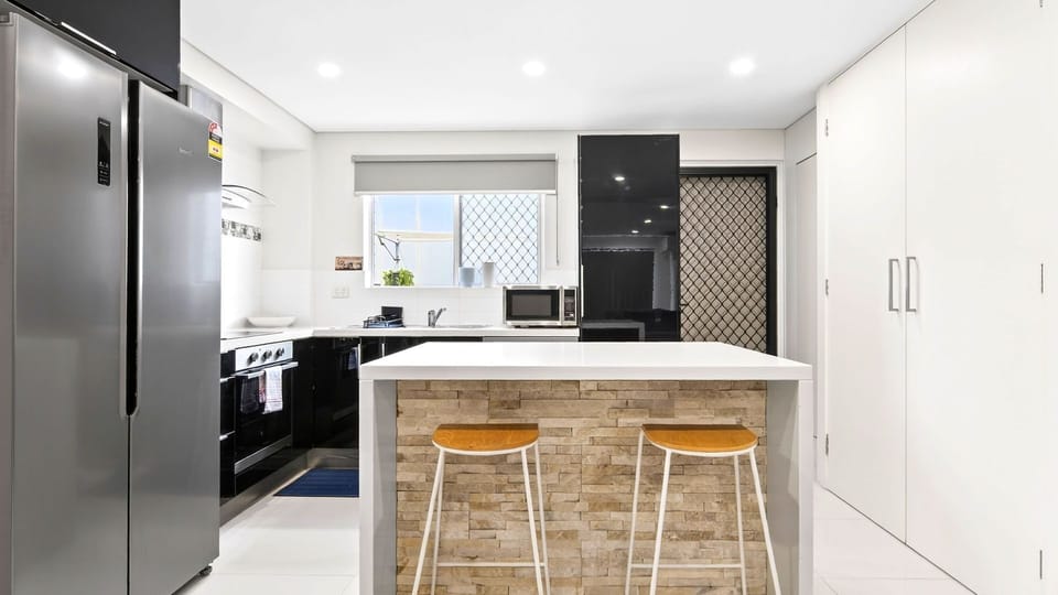Well-appointed kitchen with breakfast bar seating for casual dining.