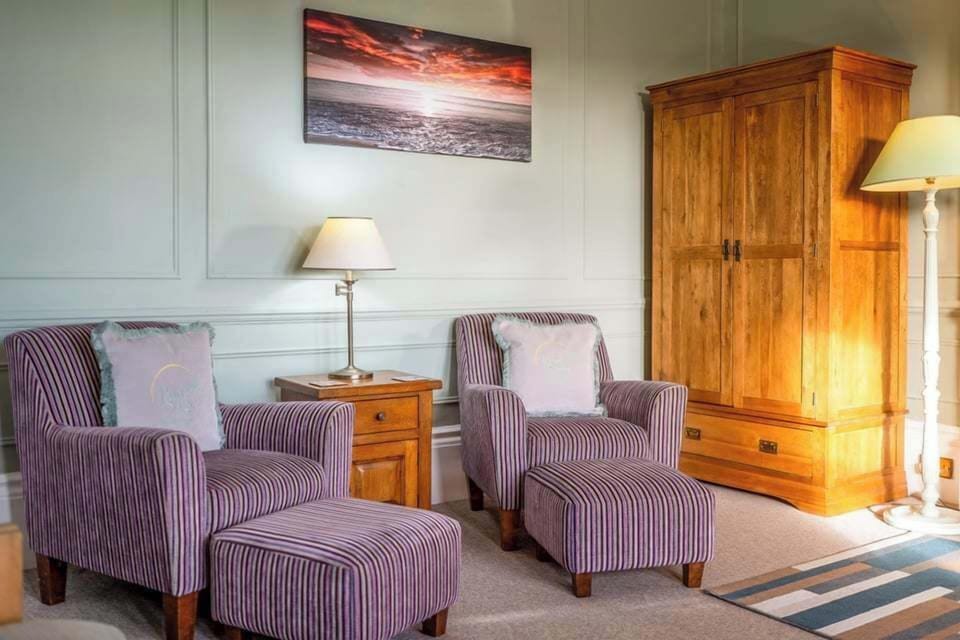 Two comfortable armchairs with a matching stool, perfect for relaxing after a day by the sea